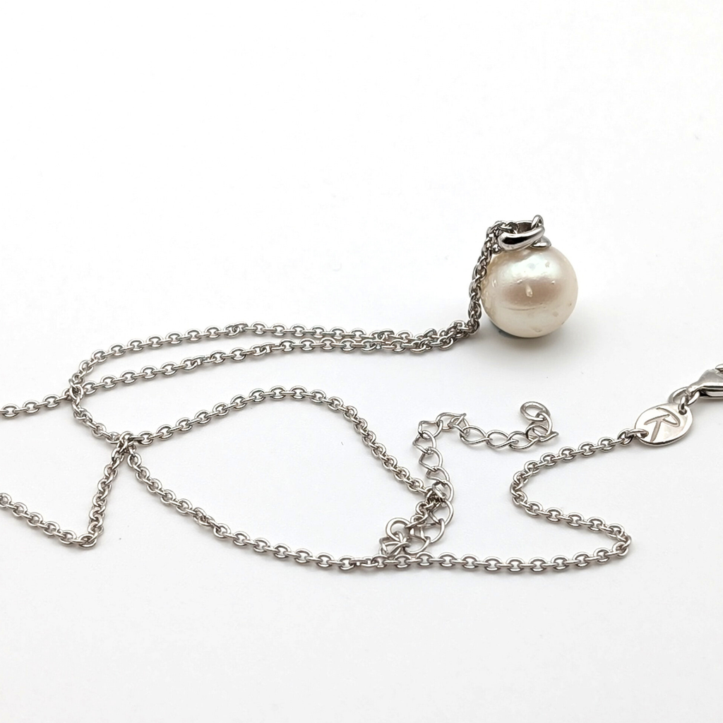 Spotted large white  south sea pearl pendant necklace with rhodium plated sterling silver chain on white background