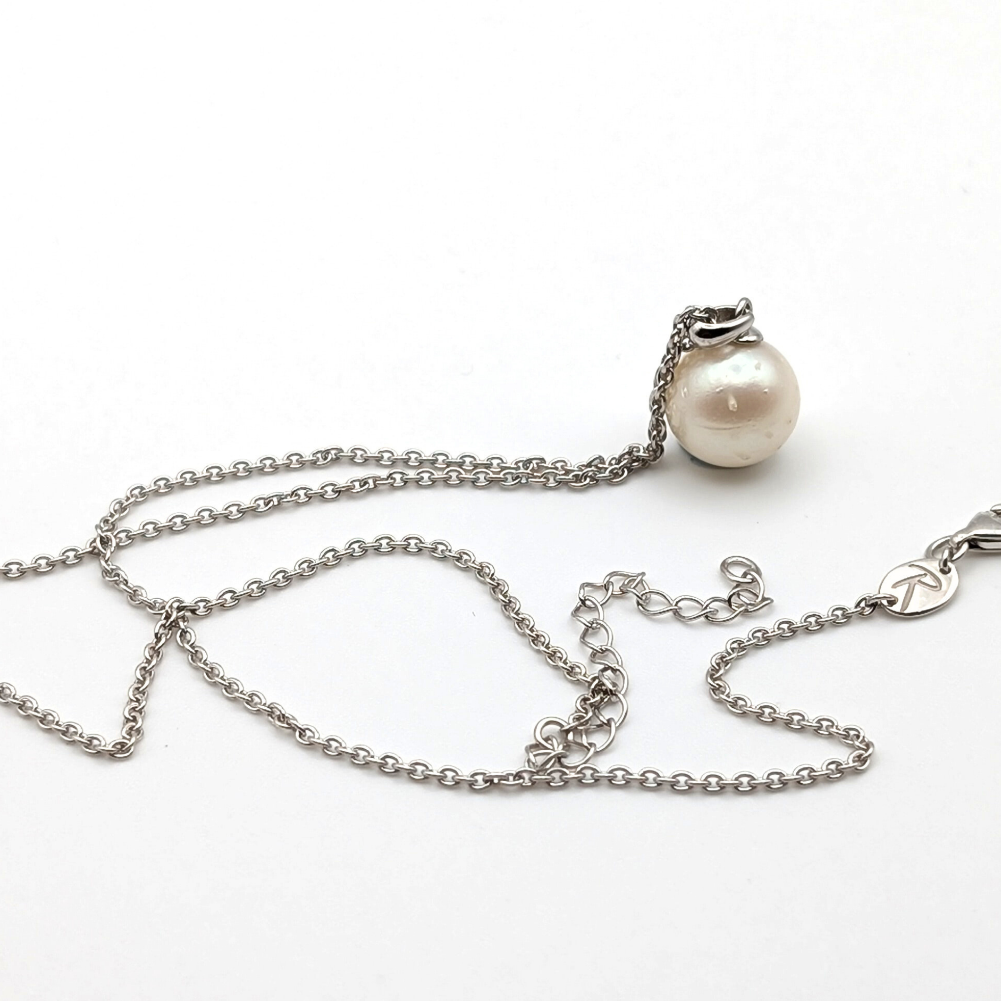 Spotted large white  south sea pearl pendant necklace with rhodium plated sterling silver chain on white background