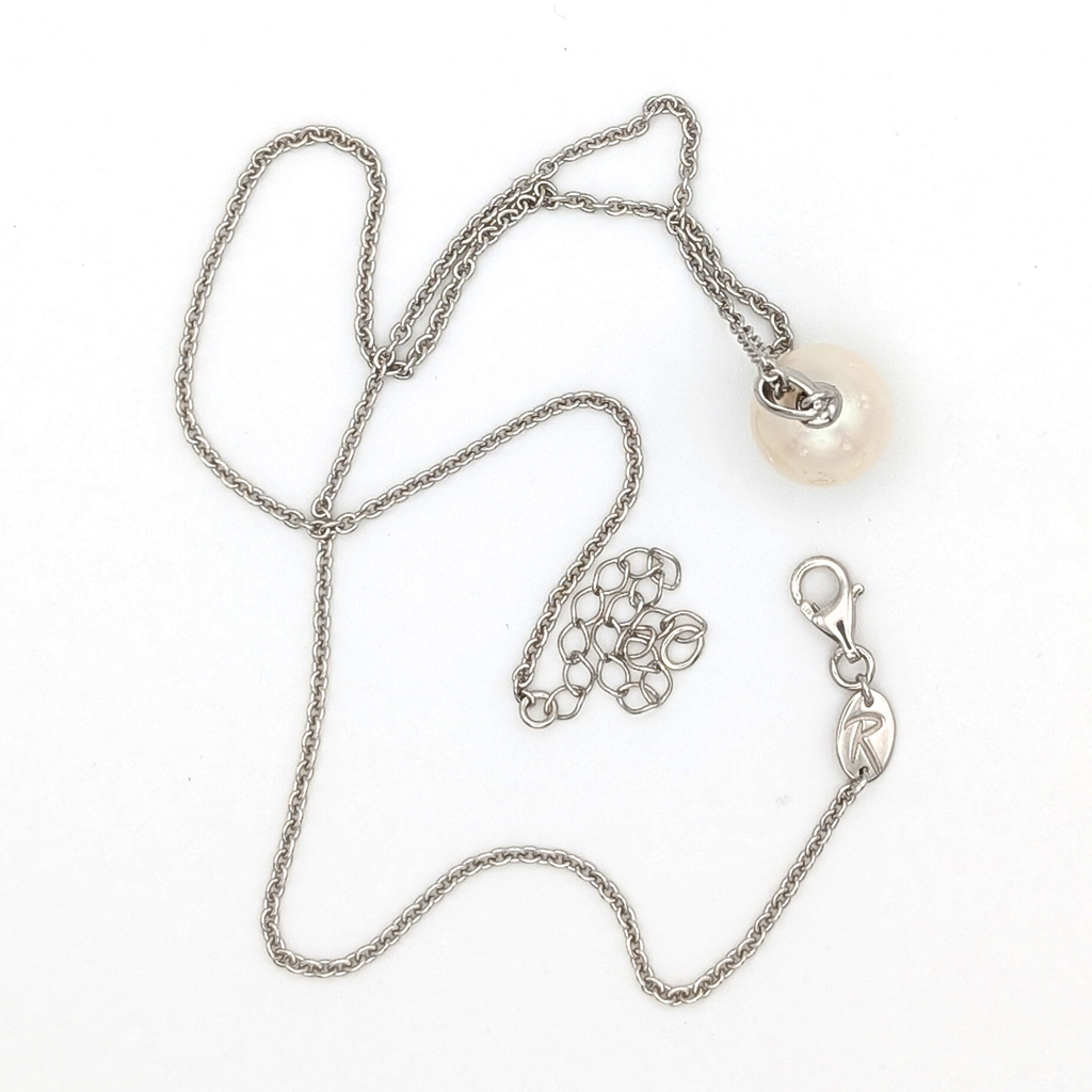 Spotted large white  south sea pearl pendant necklace with rhodium plated sterling silver chain on white background