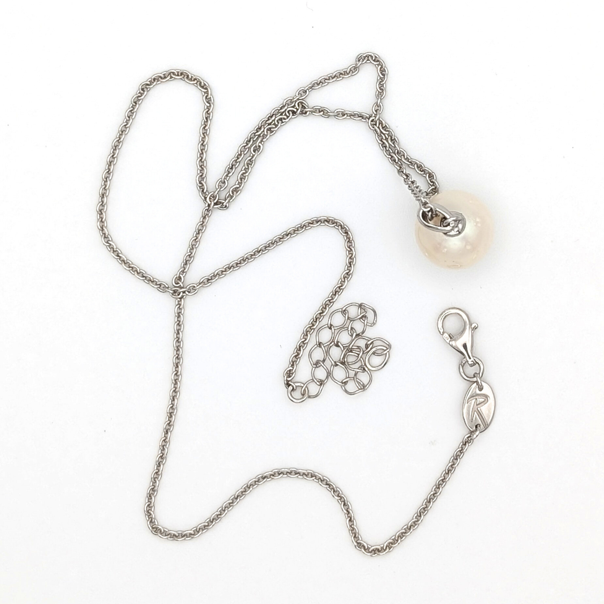 Spotted large white  south sea pearl pendant necklace with rhodium plated sterling silver chain on white background