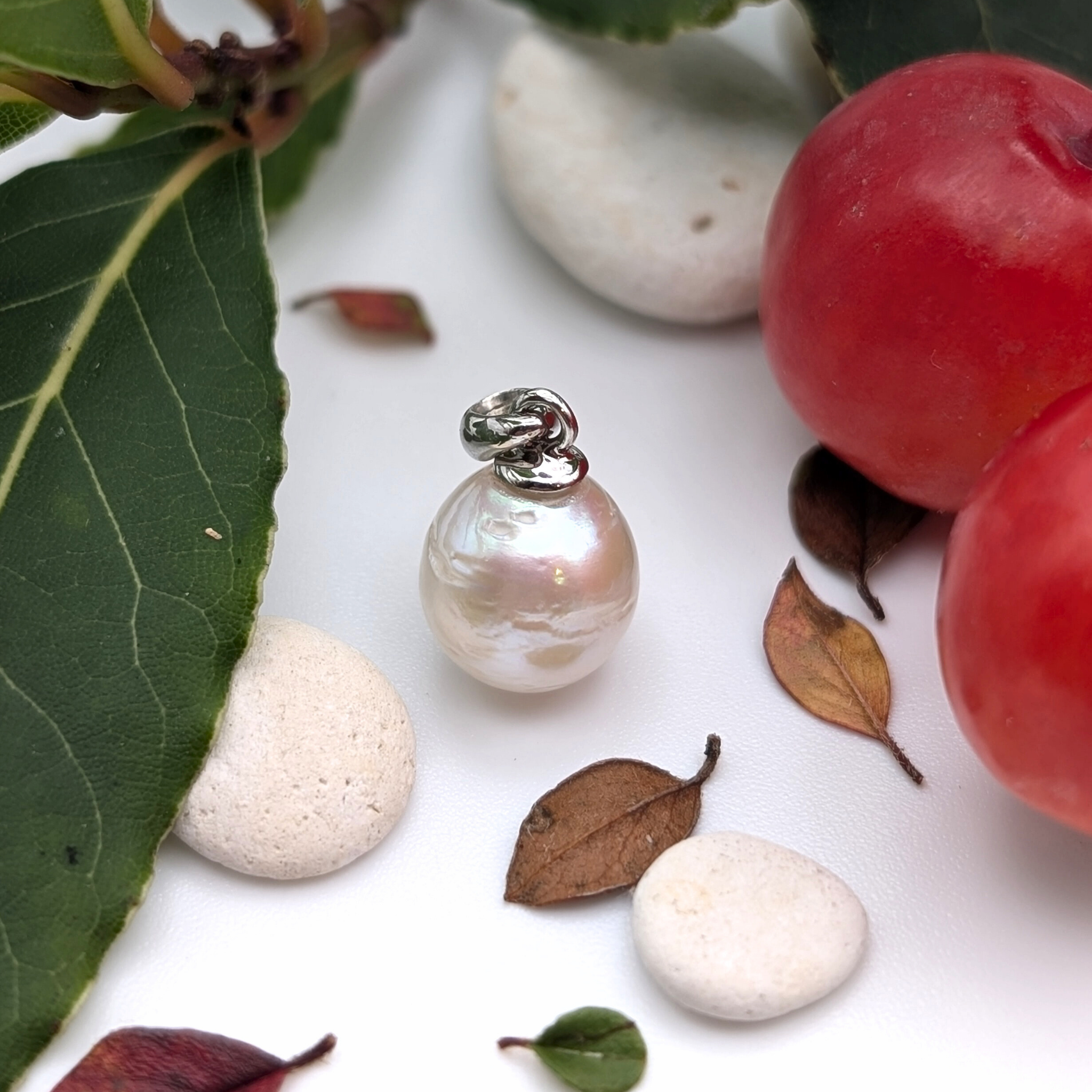 Striped medium silver white south sea pearl with three spots pendant necklace with rhodium plated sterling silver chain on lifestyle background