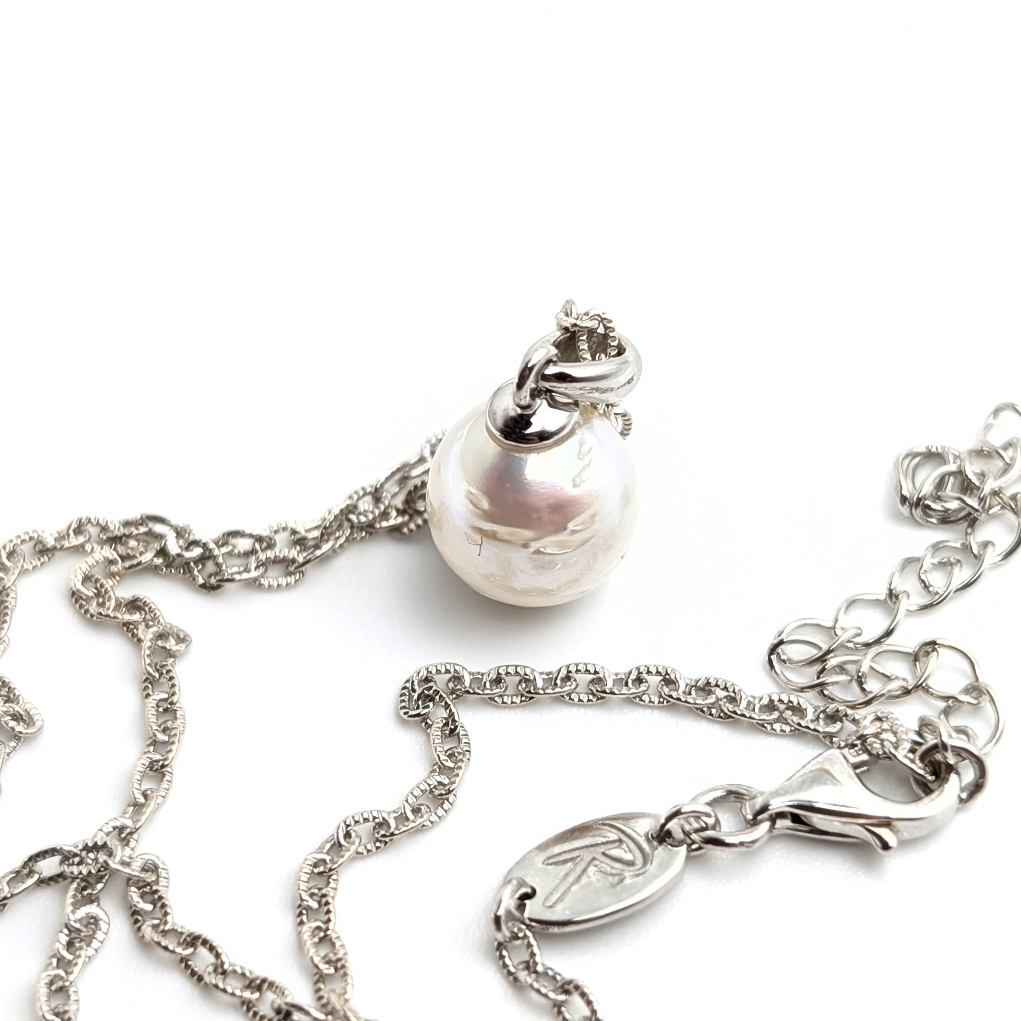 Striped medium silver white south sea pearl with three spots pendant necklace with rhodium plated sterling silver chain on white background