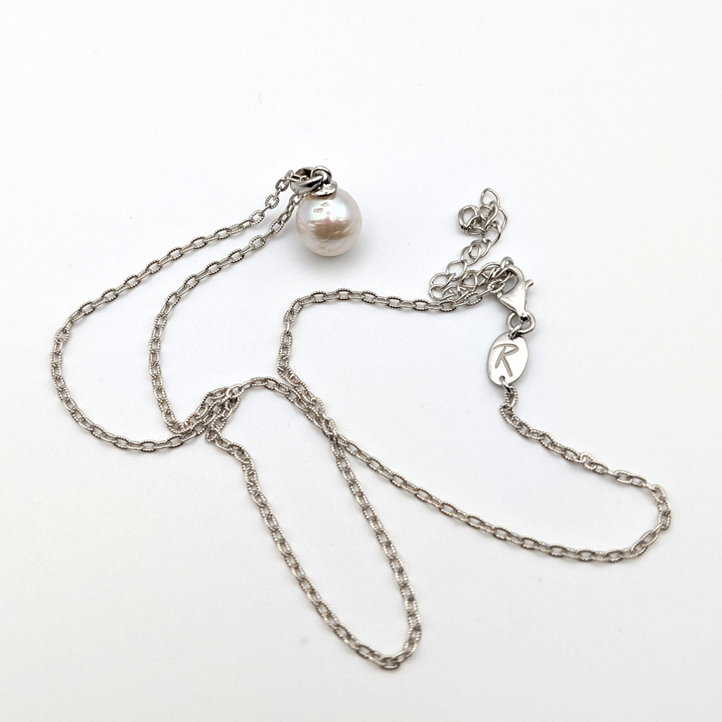 Striped medium silver white south sea pearl with three spots pendant necklace with rhodium plated sterling silver chain on white background