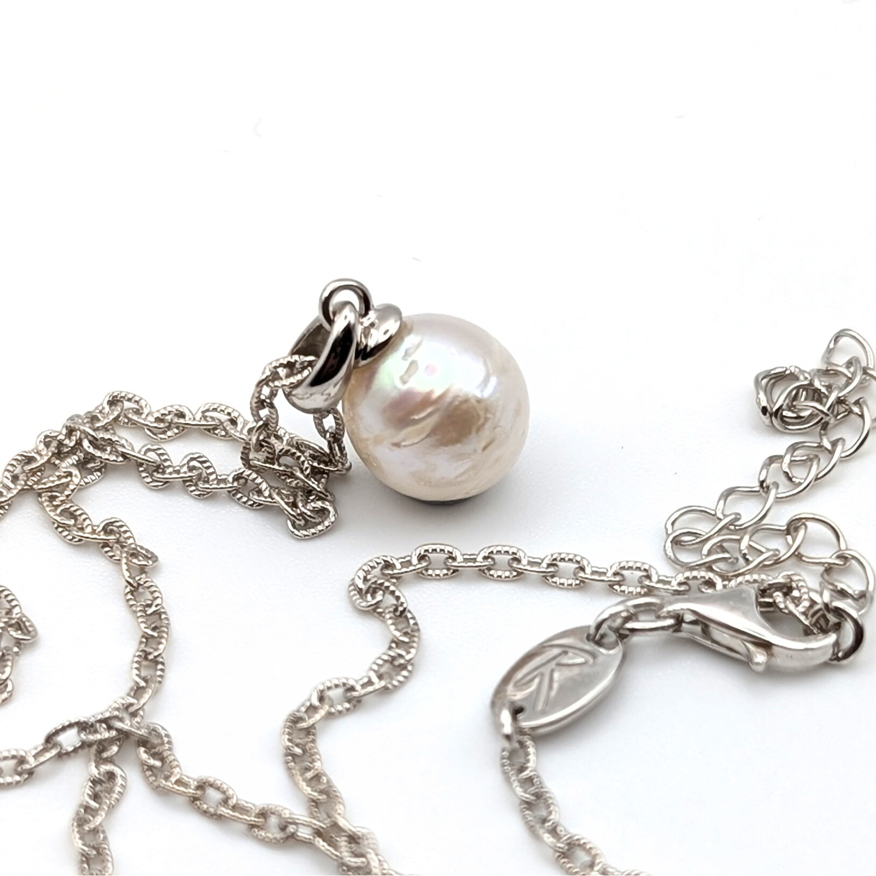 Striped medium silver white south sea pearl with three spots pendant necklace with rhodium plated sterling silver chain on white background