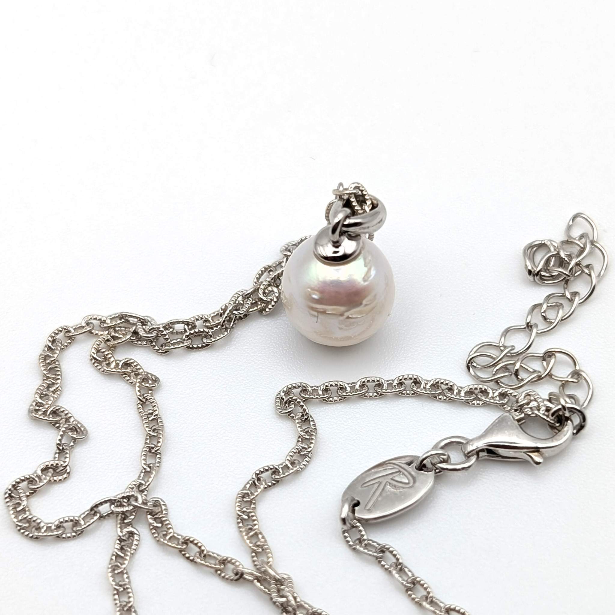 Striped medium silver white south sea pearl with three spots pendant necklace with rhodium plated sterling silver chain on white background