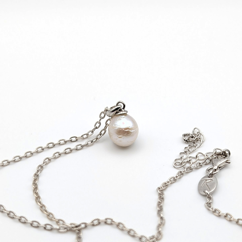 Striped medium silver white south sea pearl with three spots pendant necklace with rhodium plated sterling silver chain on white background