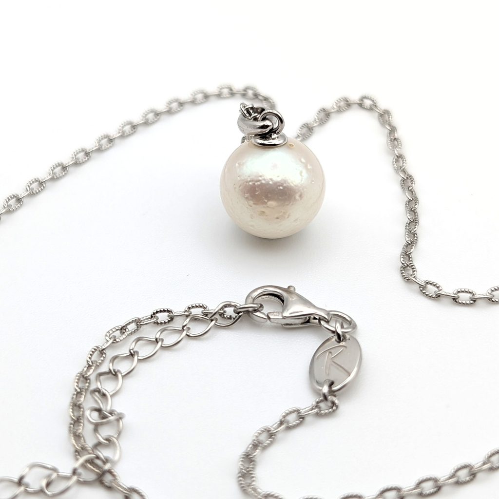 large white south sea pearl pendant necklace on a thin rhodium plated chain against a white background