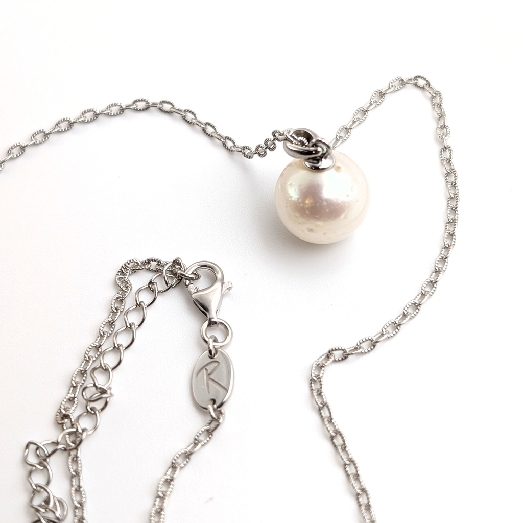 large white south sea pearl pendant necklace on a thin rhodium plated chain against a white background