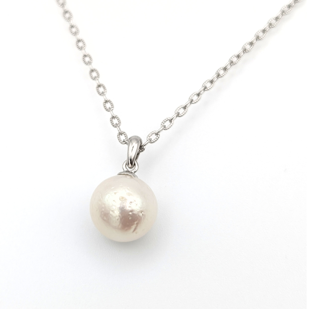 large white south sea pearl pendant necklace on a thin rhodium plated chain against a white background