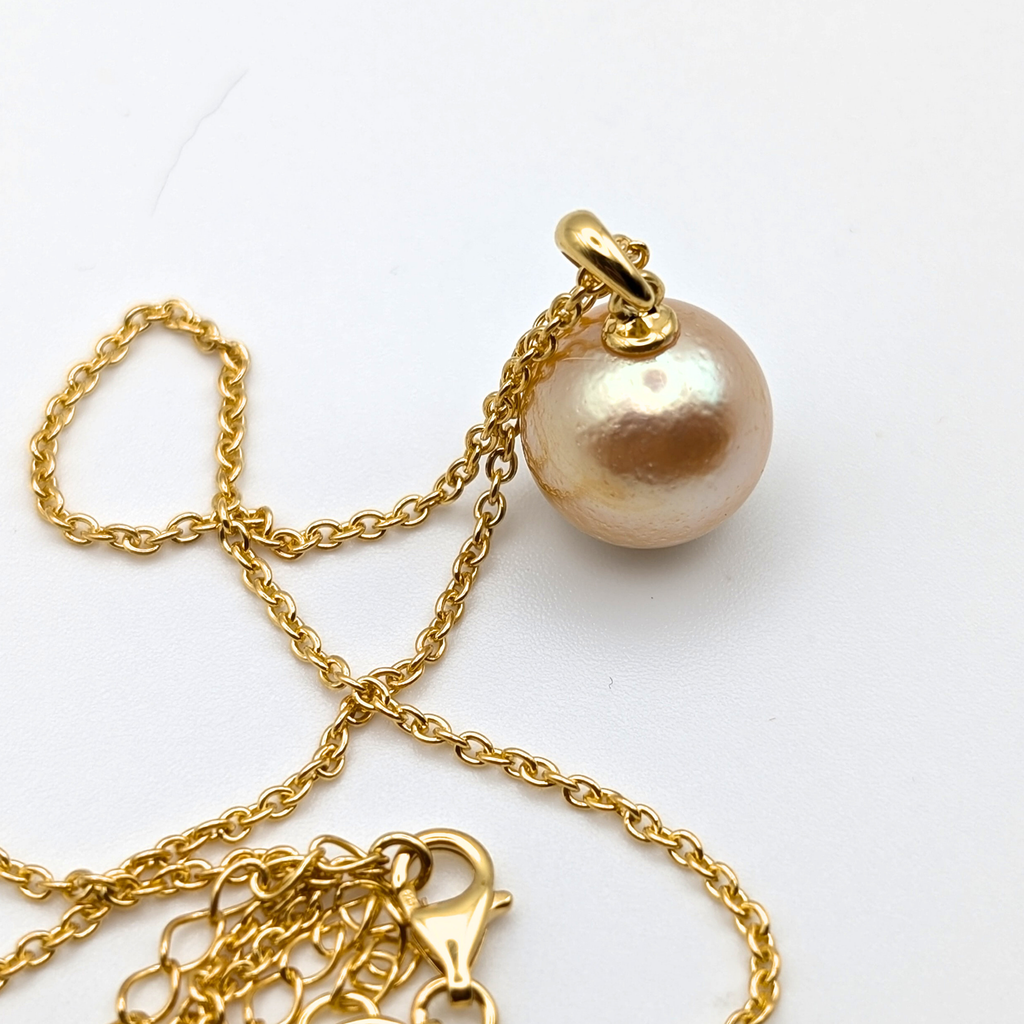 coppery gold south sea pearl pendant necklace with gold vermeil bail and chain on white background