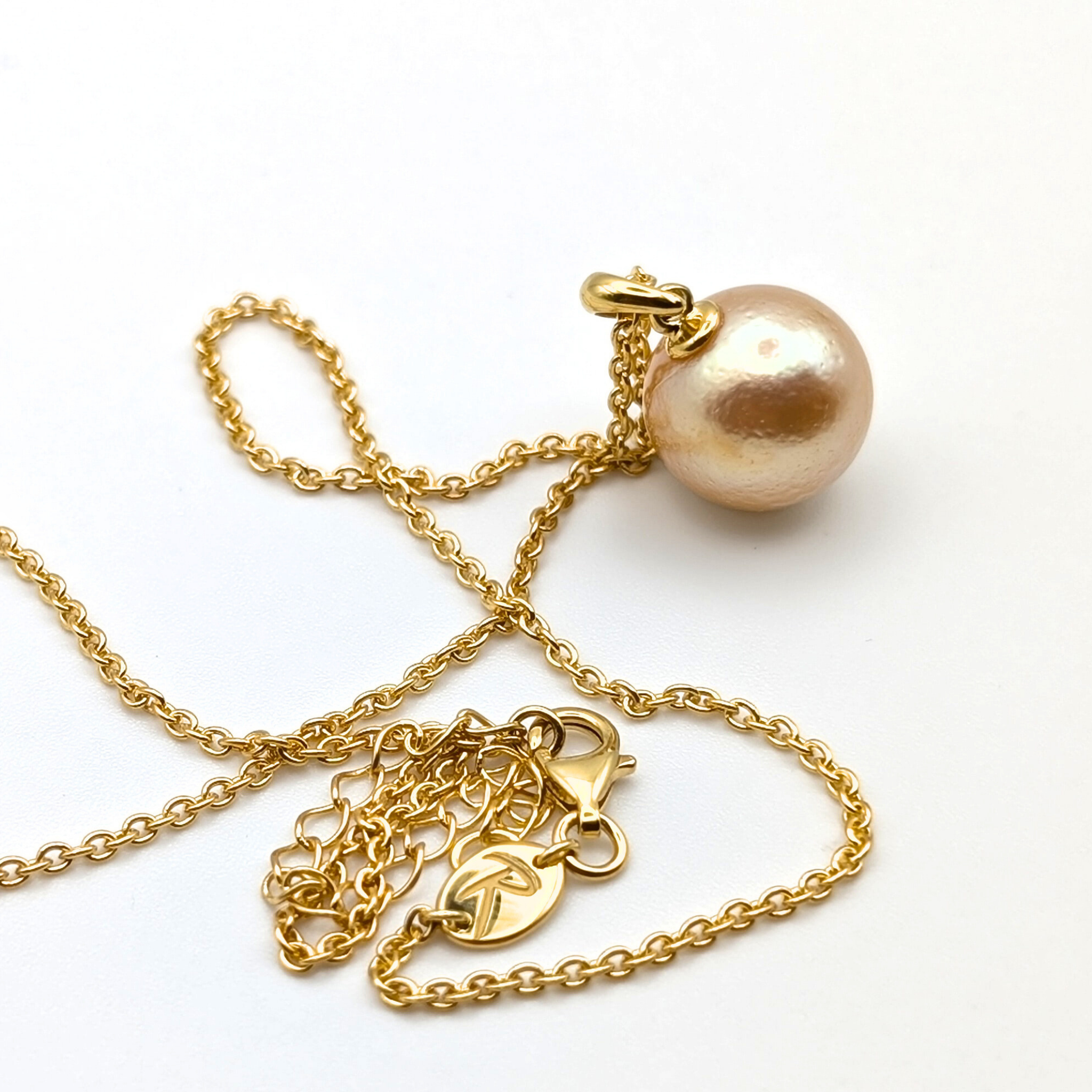 coppery gold south sea pearl pendant necklace with gold vermeil bail and chain on white background