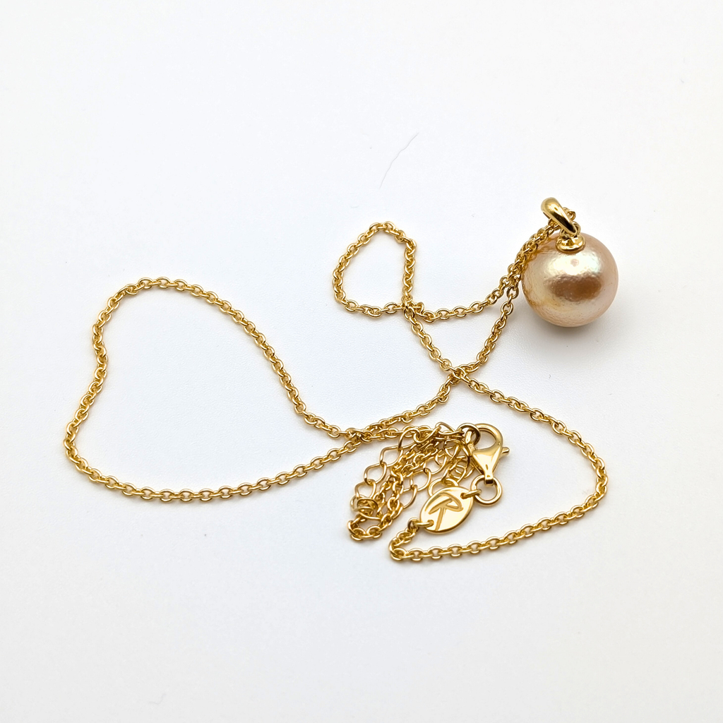 coppery gold south sea pearl pendant necklace with gold vermeil bail and chain on white background