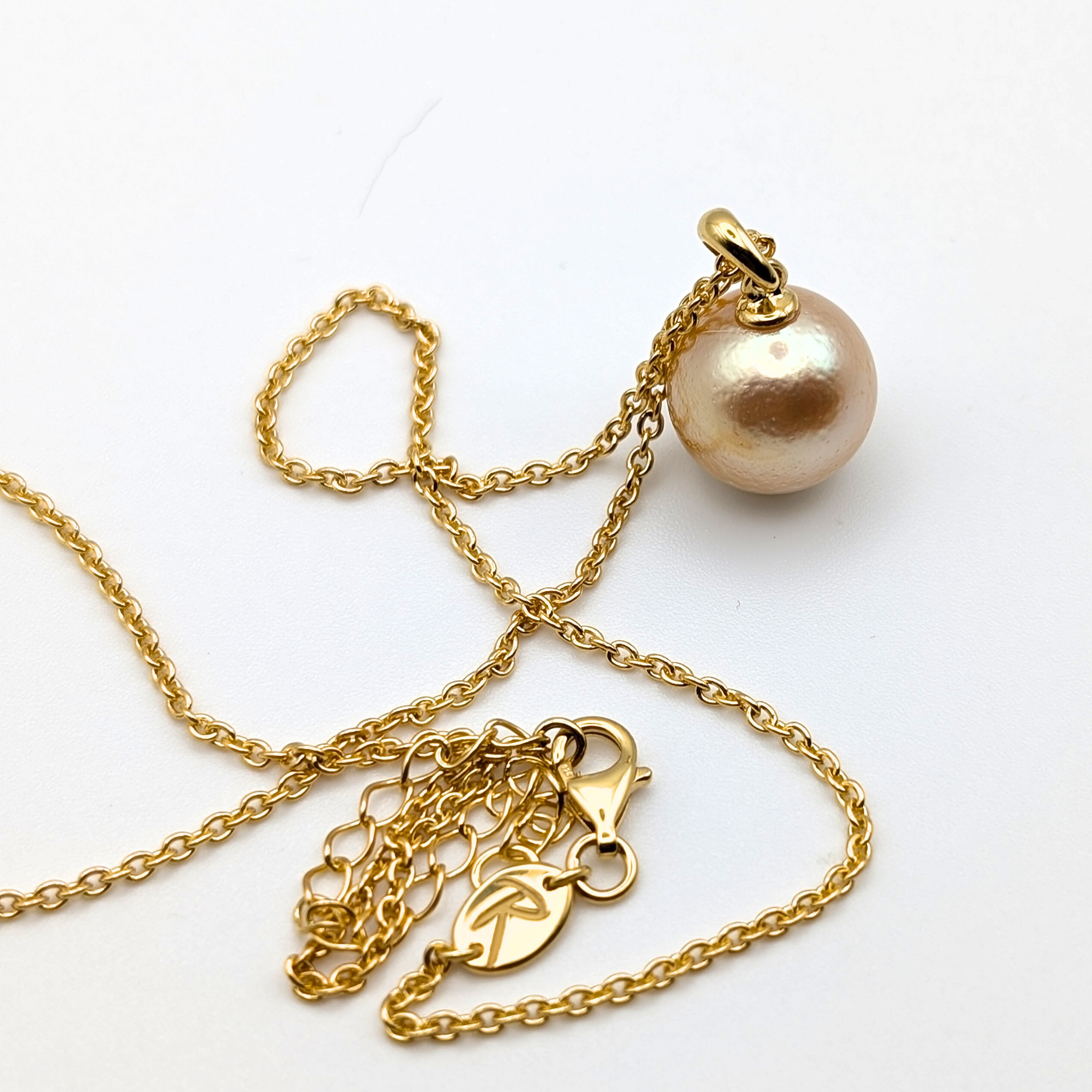 coppery gold south sea pearl pendant necklace with gold vermeil bail and chain on white background