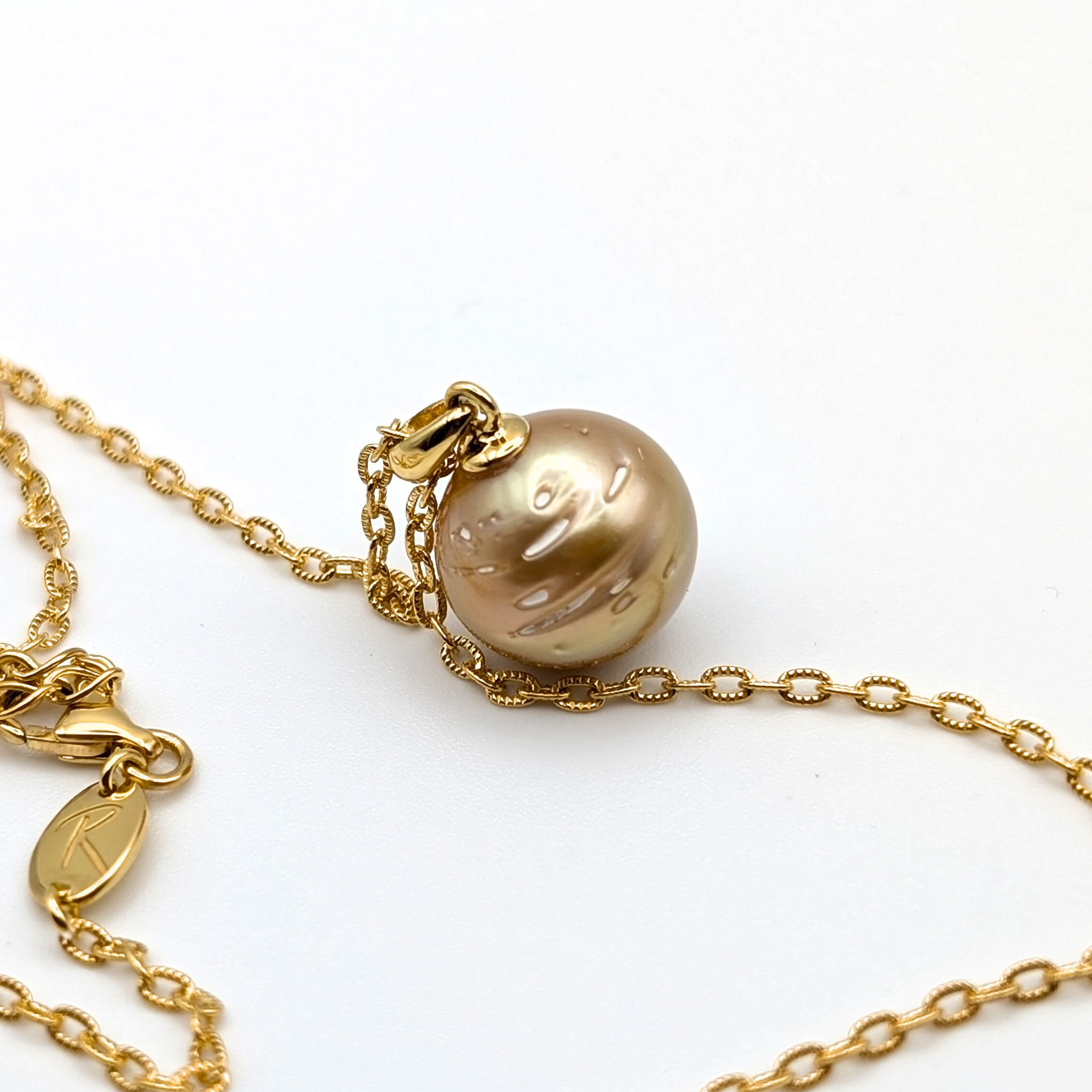 deep contour gold south sea pearl pendant necklace with gold vermeil chain on white background