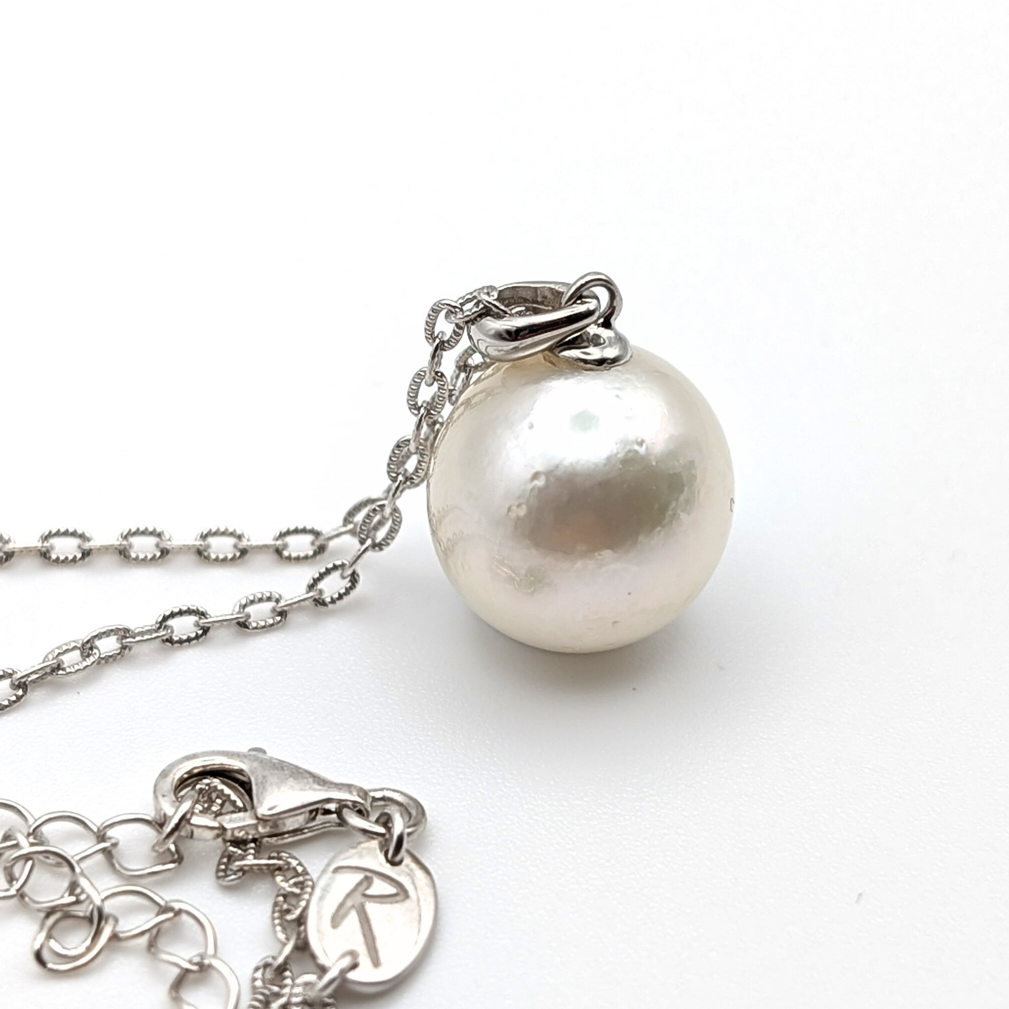 Extra large silver south sea pearl pendant necklace with rhodium plated sterling silver chain on white background