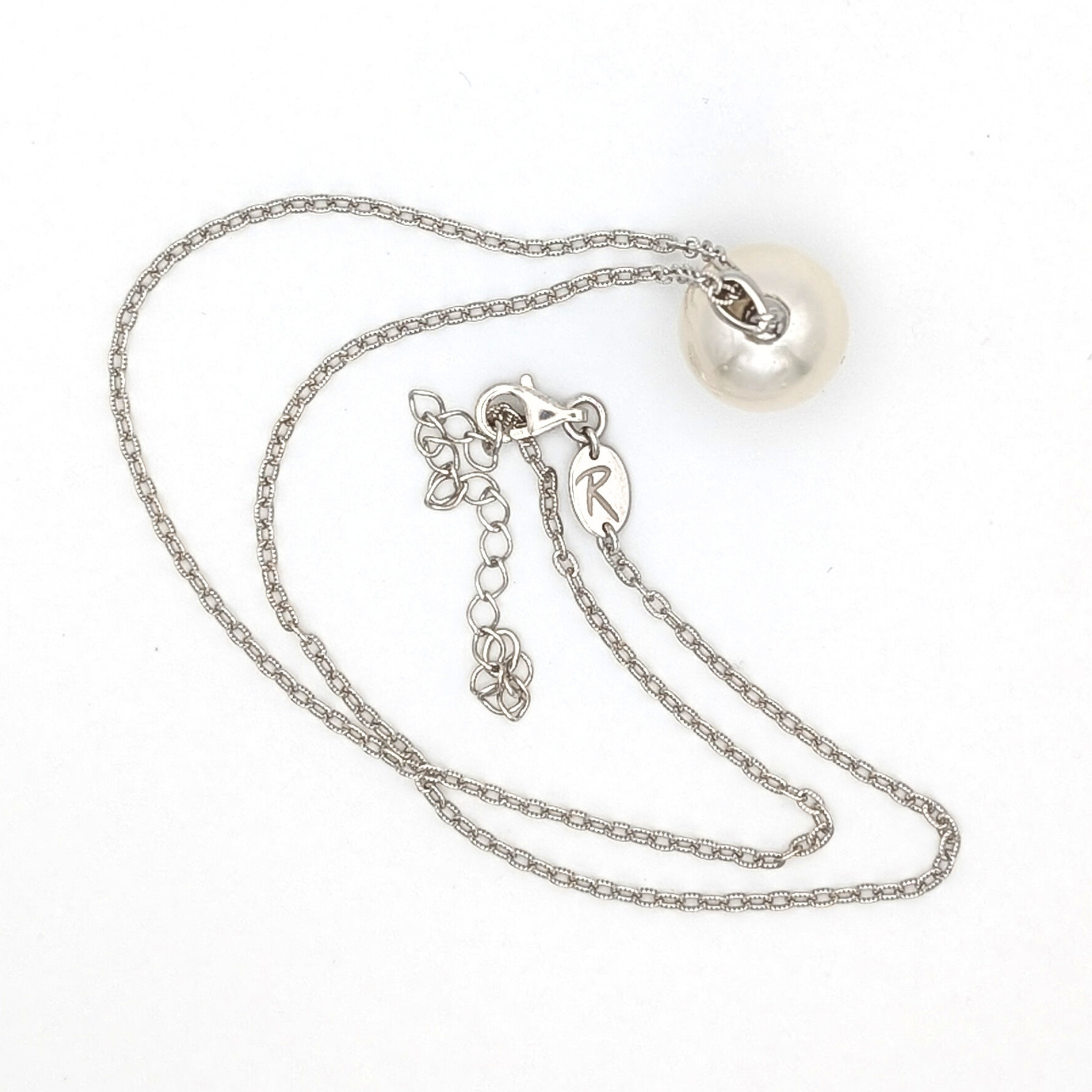 Extra large silver south sea pearl pendant necklace with rhodium plated sterling silver chain on white background