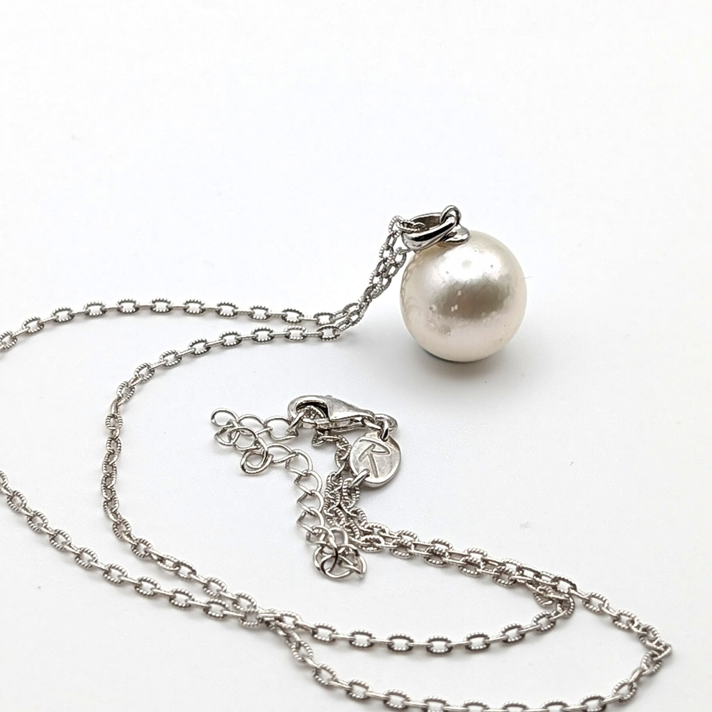 Extra large silver south sea pearl pendant necklace with rhodium plated sterling silver chain on white background