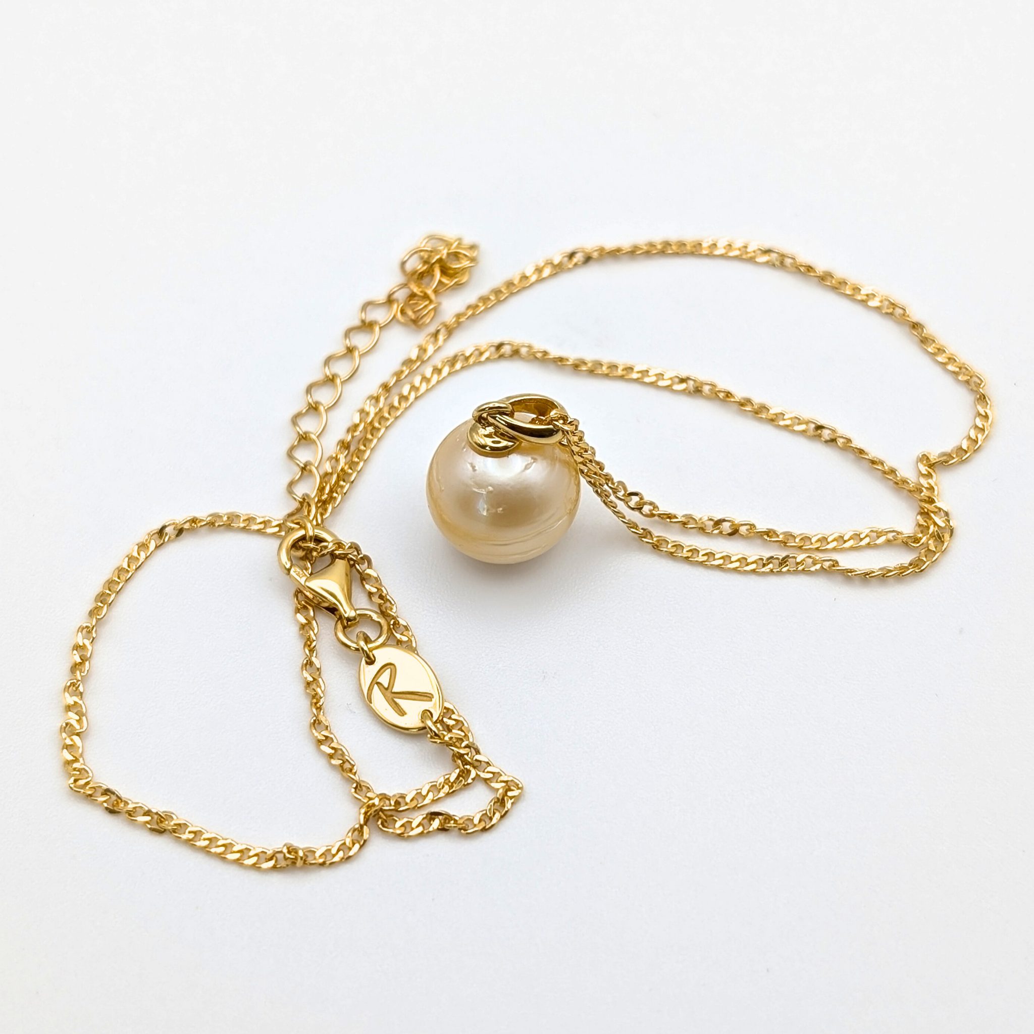 Gold vermeil necklace with a large gold south sea pearl pendant on a white background