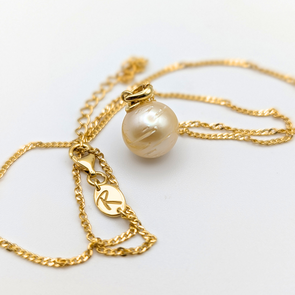 Gold vermeil necklace with a large gold south sea pearl pendant on a white background