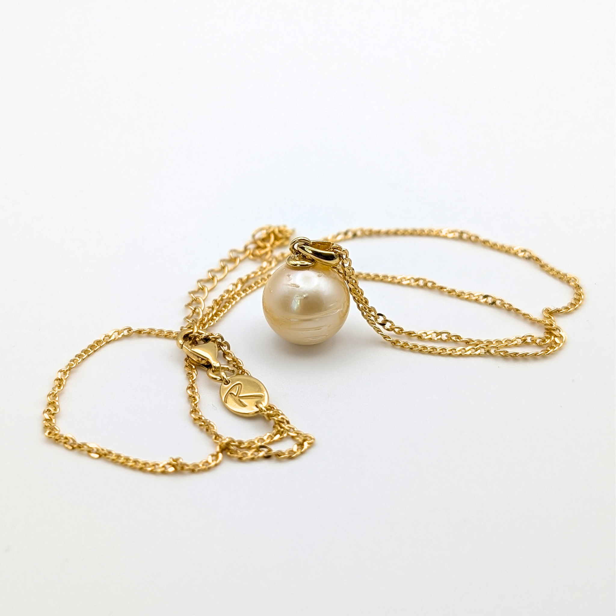 Gold vermeil necklace with a large gold south sea pearl pendant on a white background