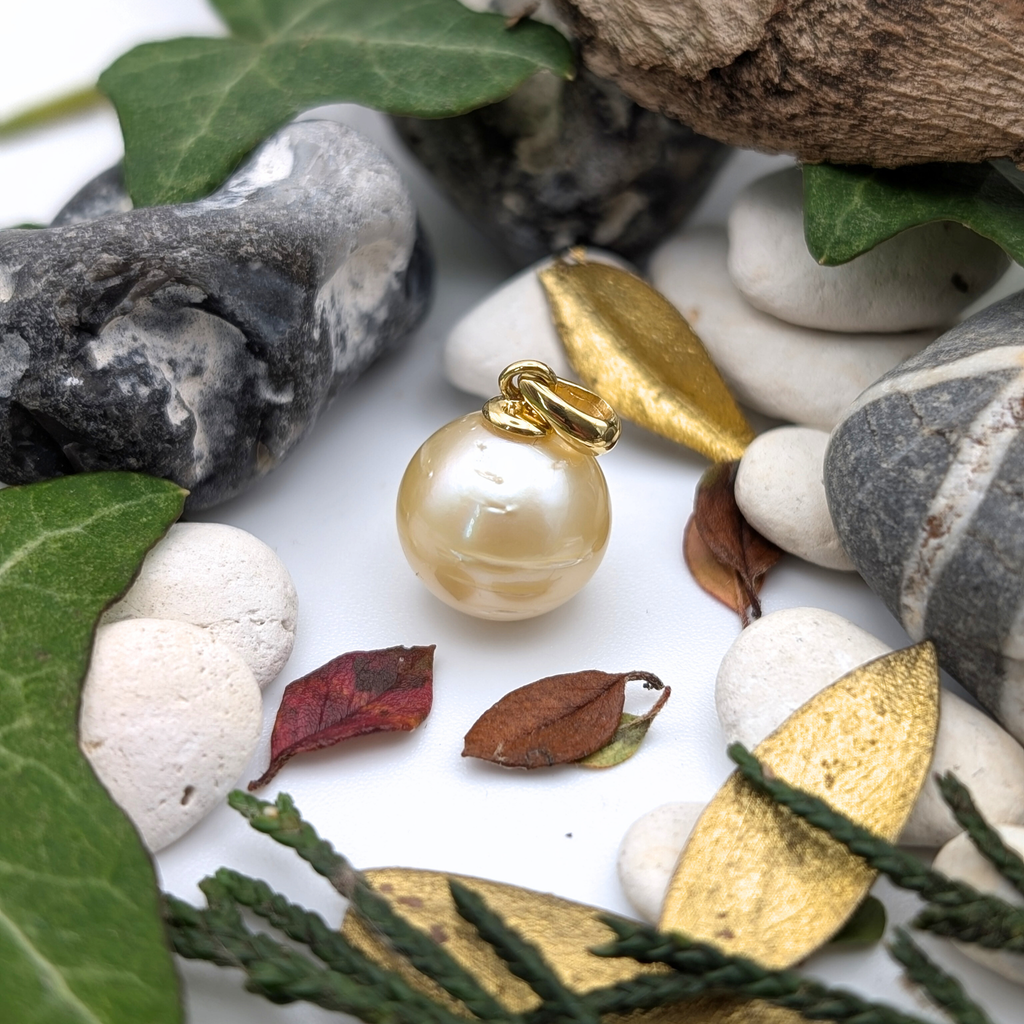 Gold vermeil necklace with a large gold south sea pearl pendant with lifestyle background