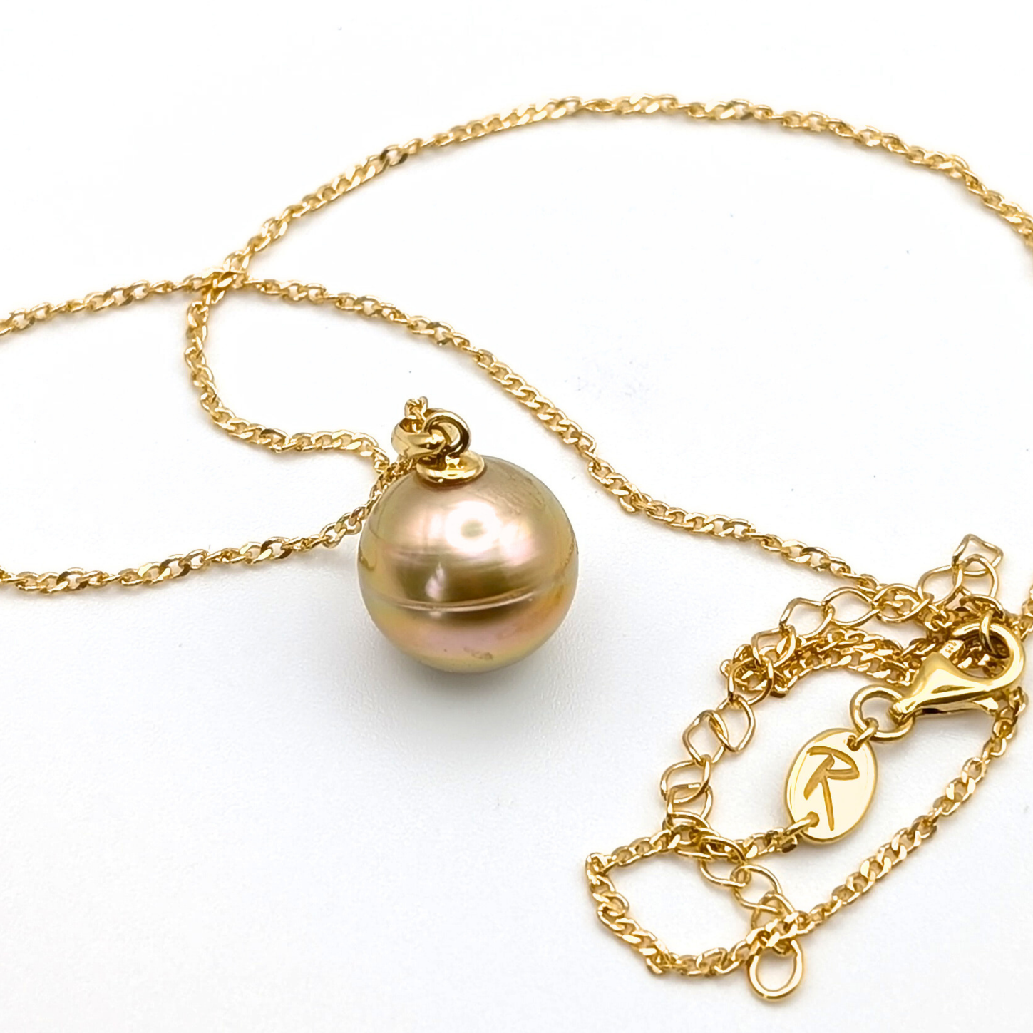 Gold necklace with a large gold south sea pearl pendant on a white background