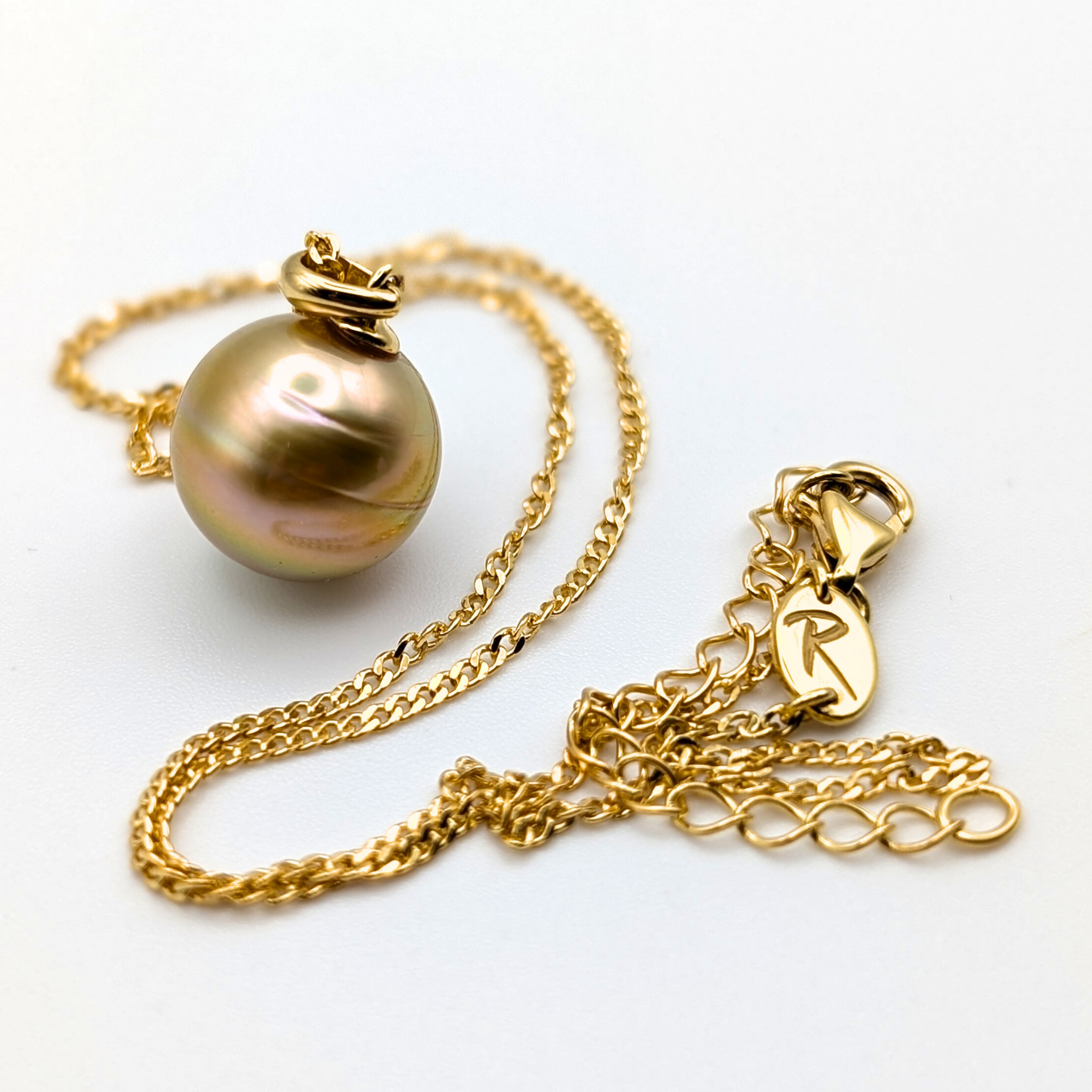 Gold necklace with a large gold south sea pearl pendant on a white background