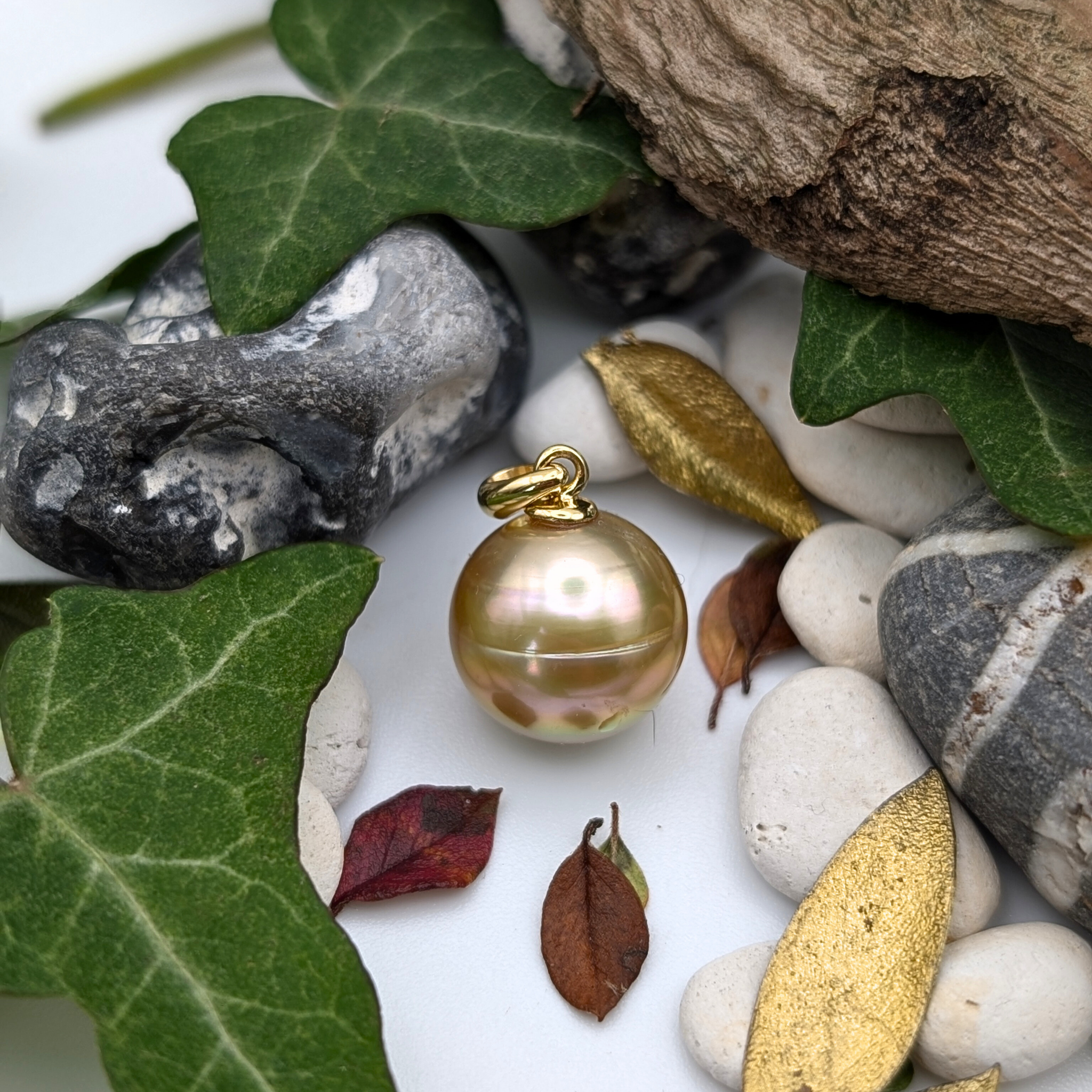 Gold necklace with a large gold south sea pearl pendant on a lifestyle background