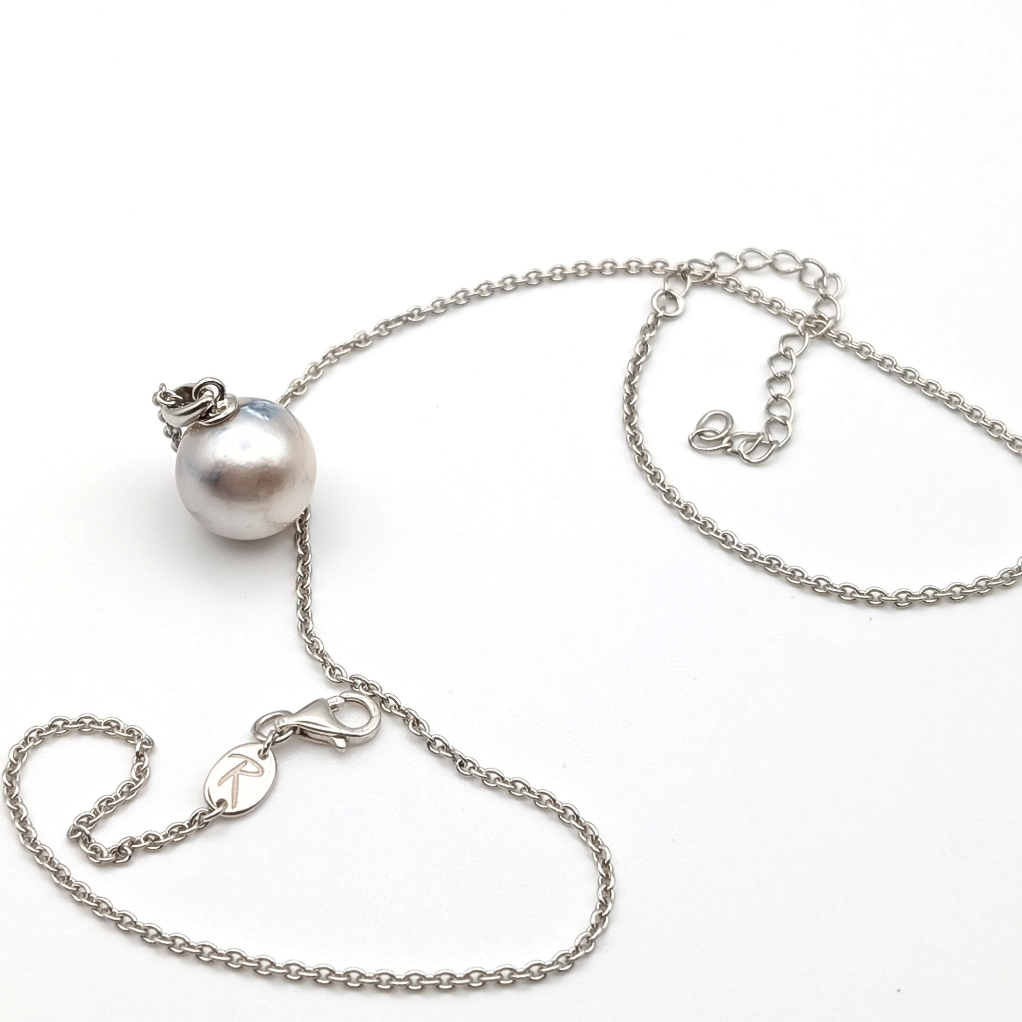 Rhodium plated sterling silver necklace with a large silver south sea pearl pendant on a white background