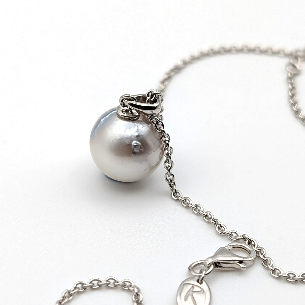 Rhodium plated sterling silver necklace with a large silver south sea pearl pendant on a white background