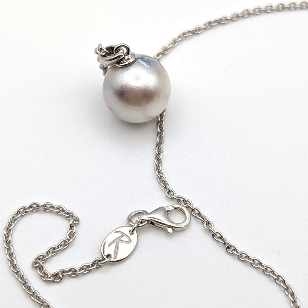 Rhodium plated sterling silver necklace with a large silver south sea pearl pendant on a white background