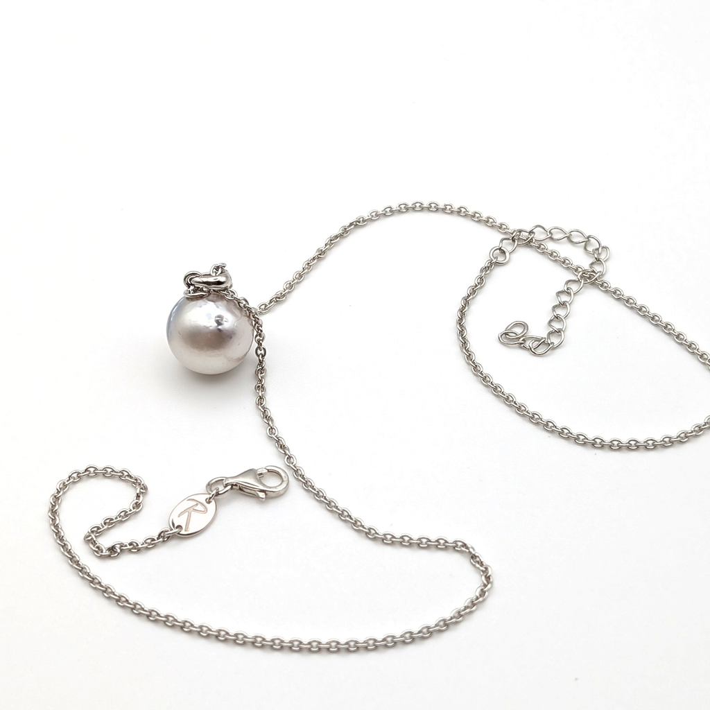 Rhodium plated sterling silver necklace with a large silver south sea pearl pendant on a white background