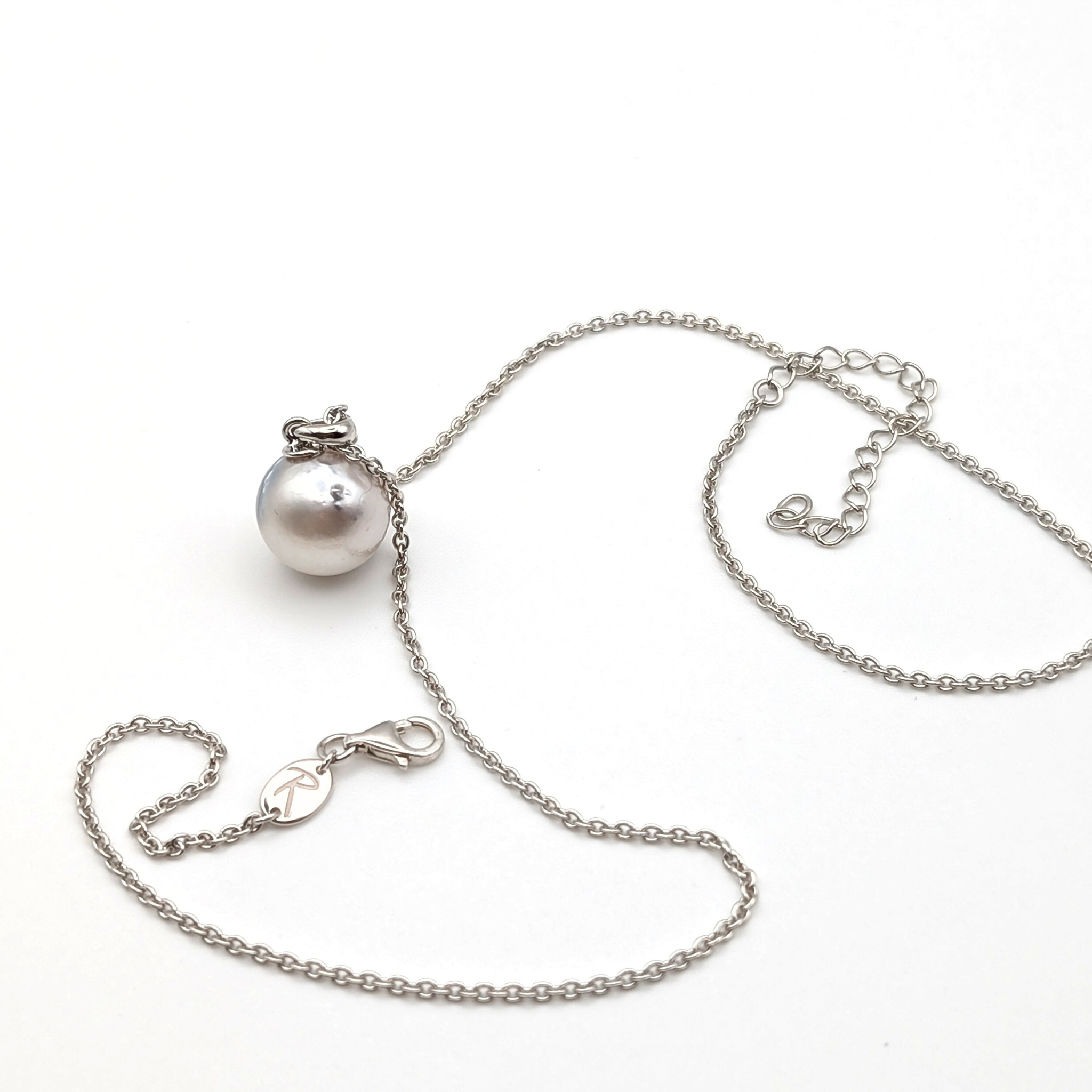 Rhodium plated sterling silver necklace with a large silver south sea pearl pendant on a white background