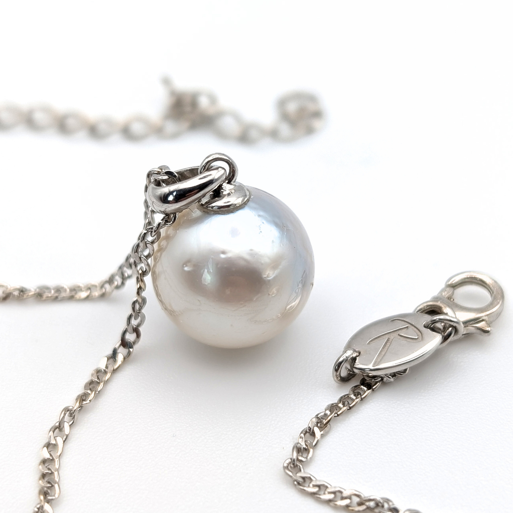 Rhodium plated sterling silver necklace with a large silver south sea pearl pendant on a white background