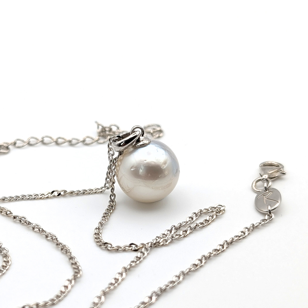 Rhodium plated sterling silver necklace with a large silver south sea pearl pendant on a white background