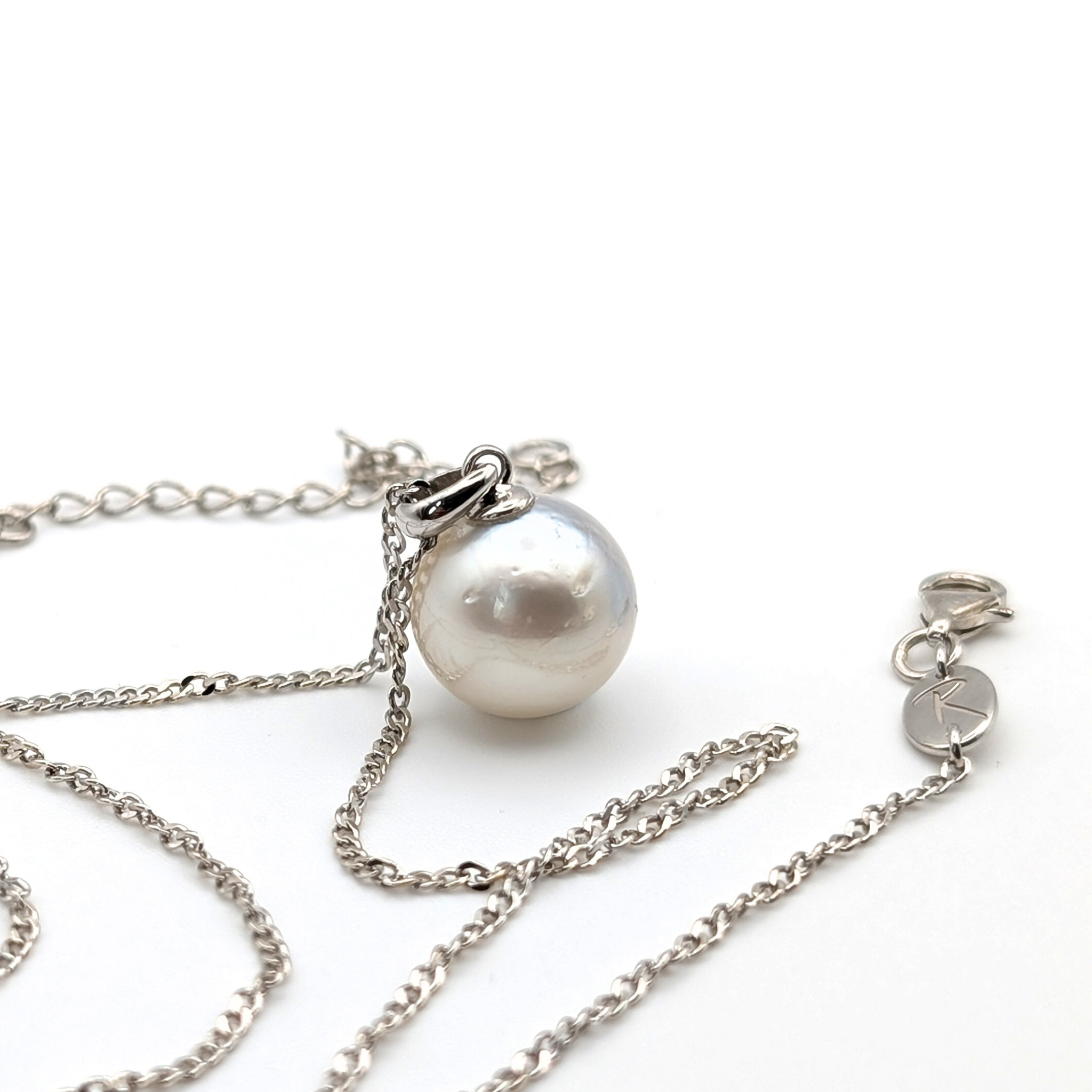 Rhodium plated sterling silver necklace with a large silver south sea pearl pendant on a white background
