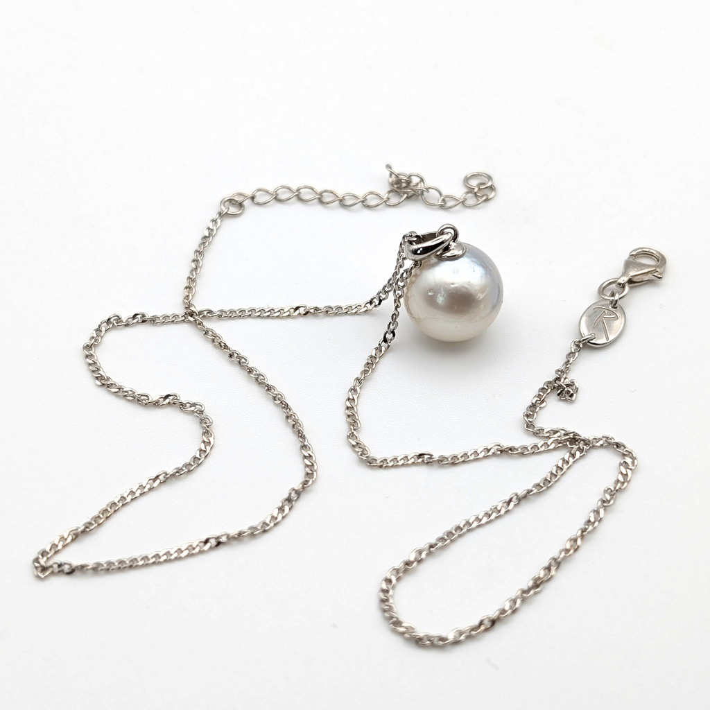 Rhodium plated sterling silver necklace with a large silver south sea pearl pendant on a white background