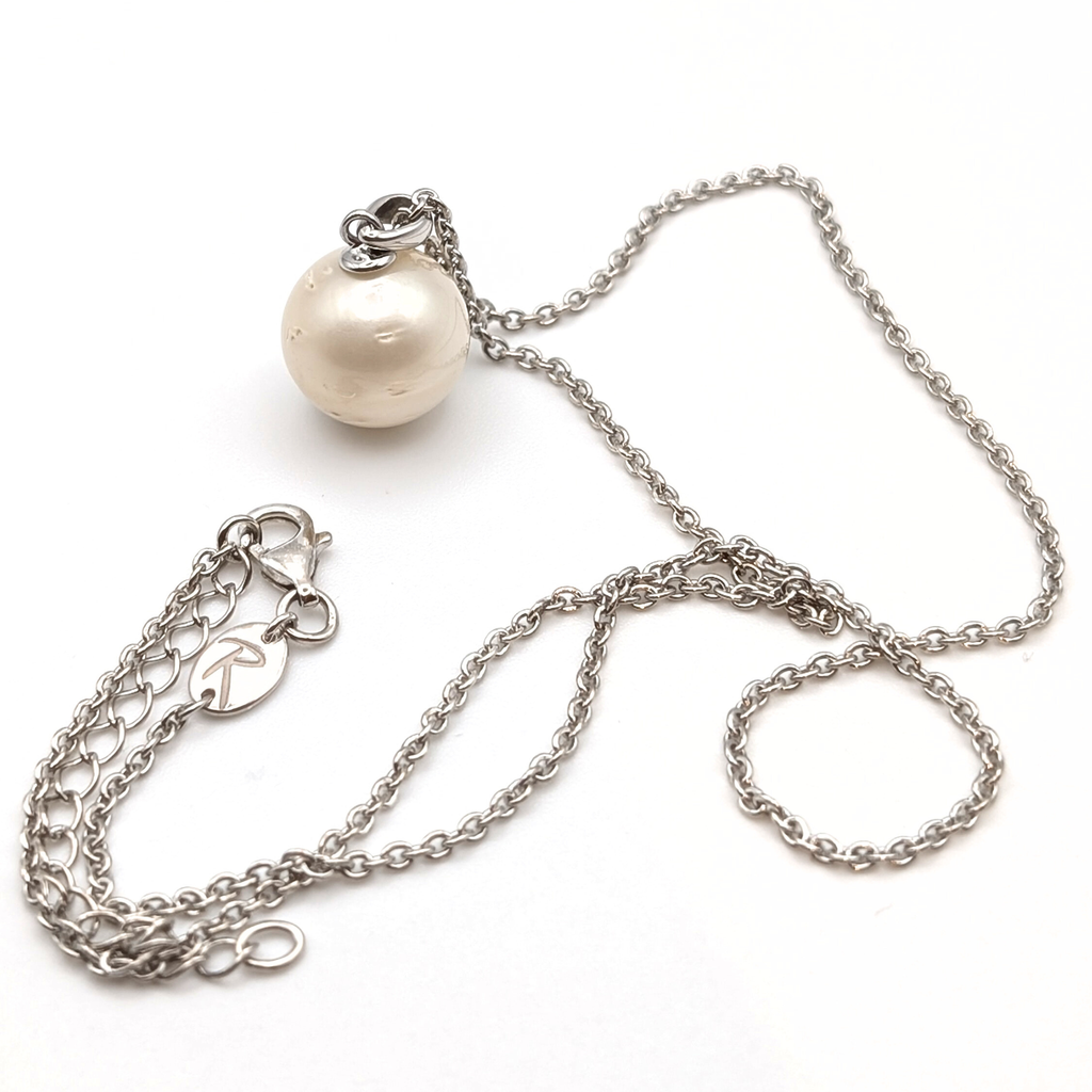 Rhodium plated sterling silver necklace with a large white spotted south sea pearl pendant on a white background