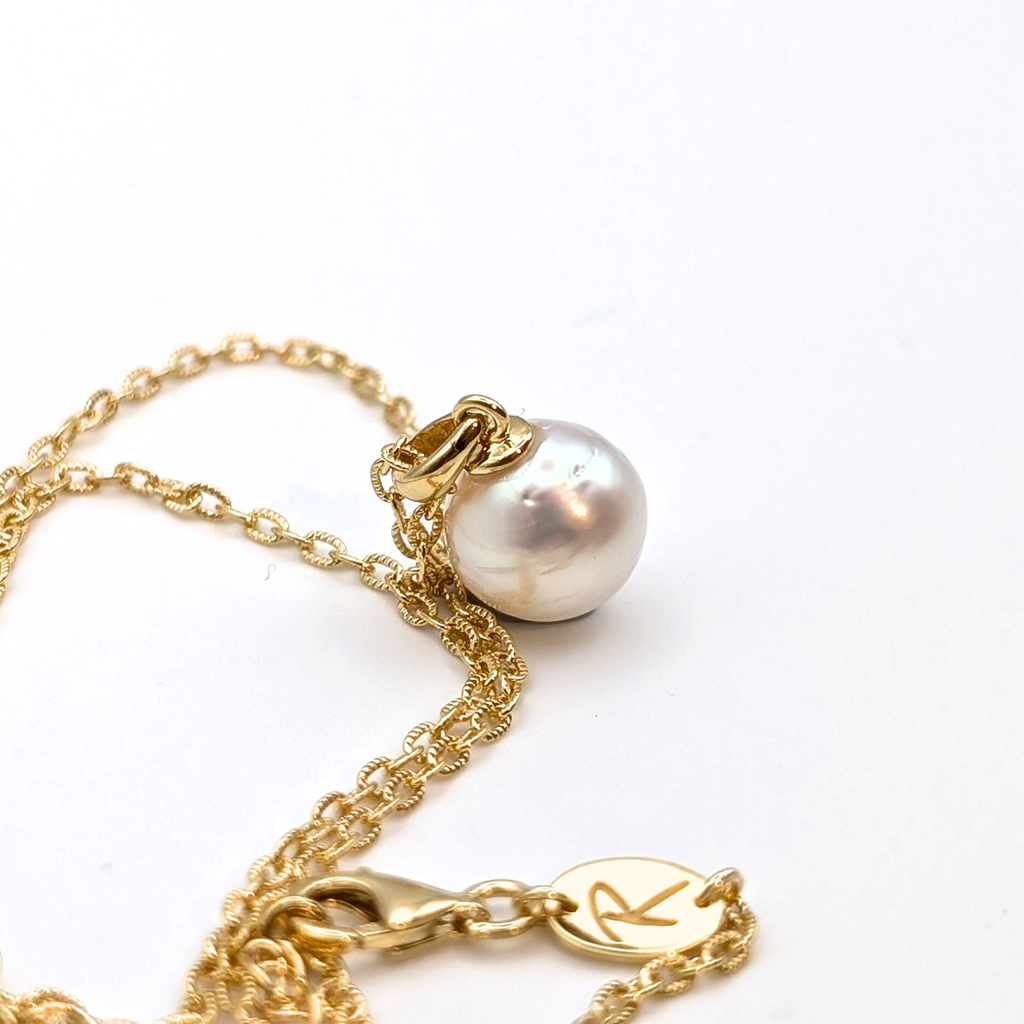 Gold vermeil chain with a white south sea pearl pendant on a white background