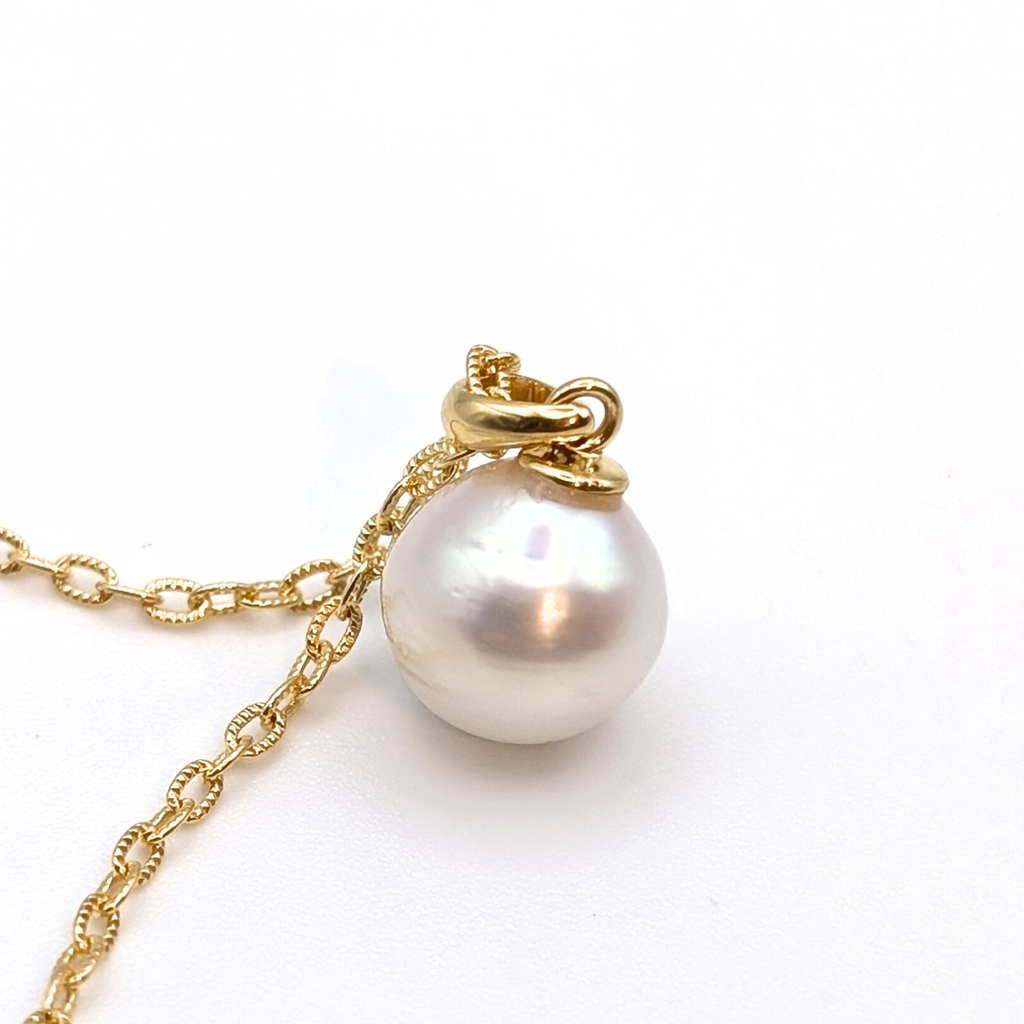 Gold vermeil chain with a white south sea pearl pendant on a white background