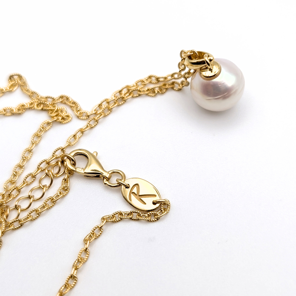 Gold vermeil chain with a white south sea pearl pendant on a white background