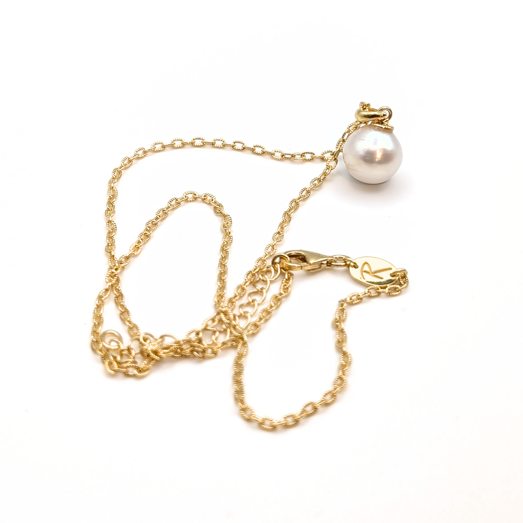 Gold vermeil chain with a white south sea pearl pendant on a white background