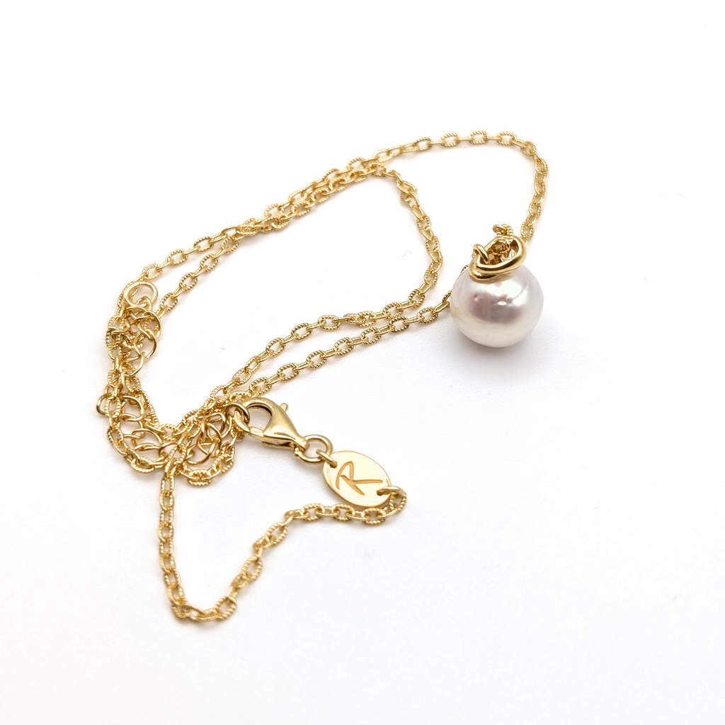 Gold vermeil chain with a white south sea pearl pendant on a white background