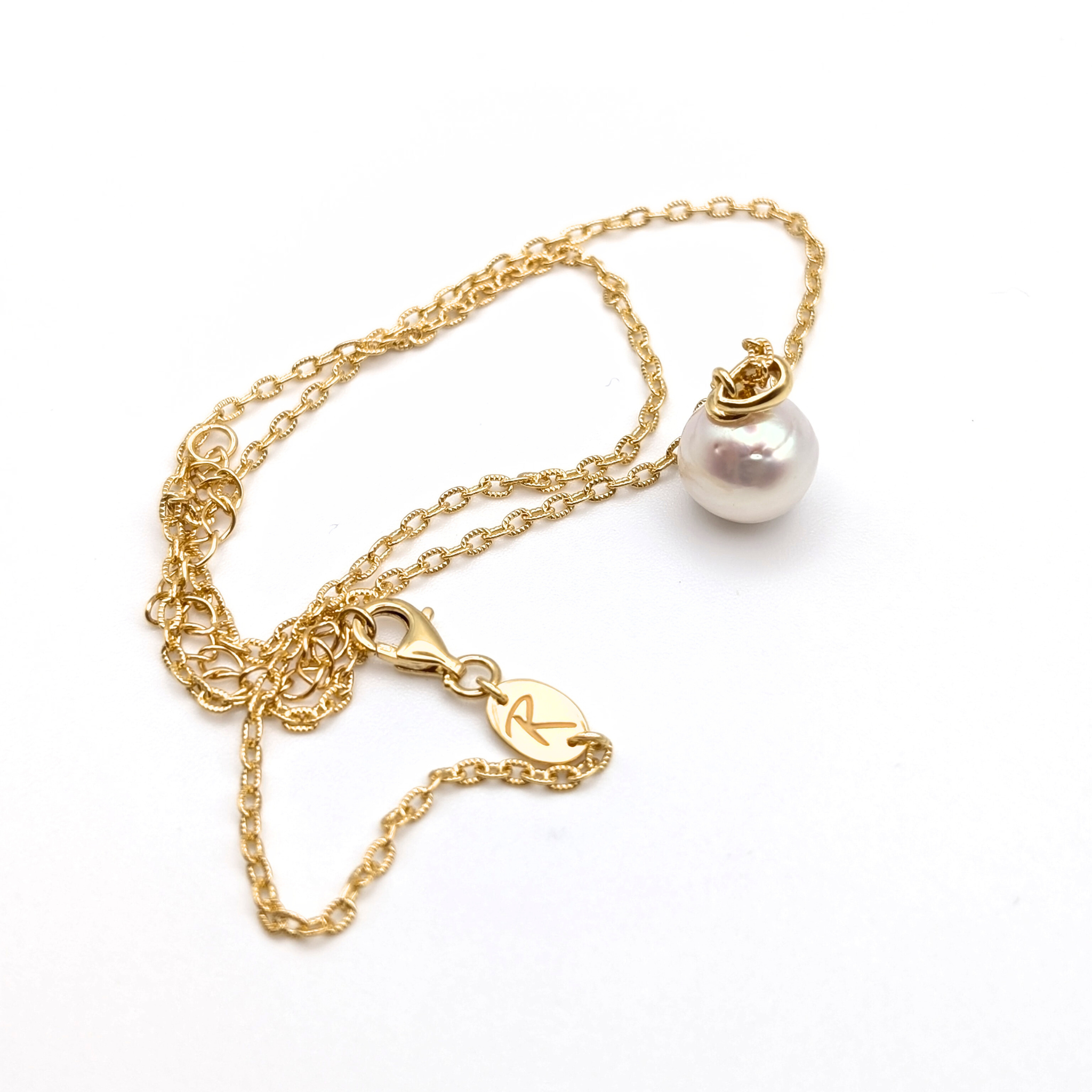 Gold vermeil chain with a white south sea pearl pendant on a white background