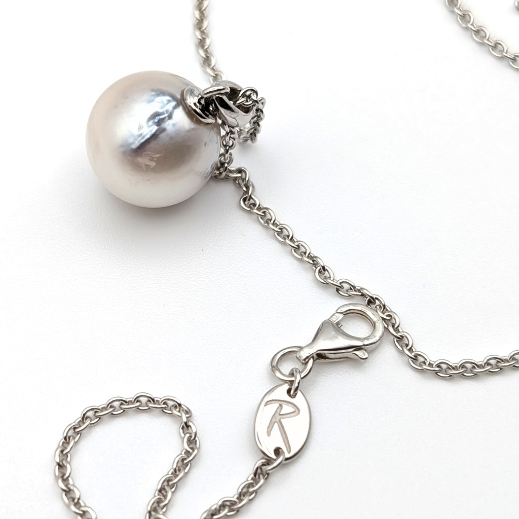 Rhodium plated sterling silver necklace with a large silver south sea pearl pendant on a white background