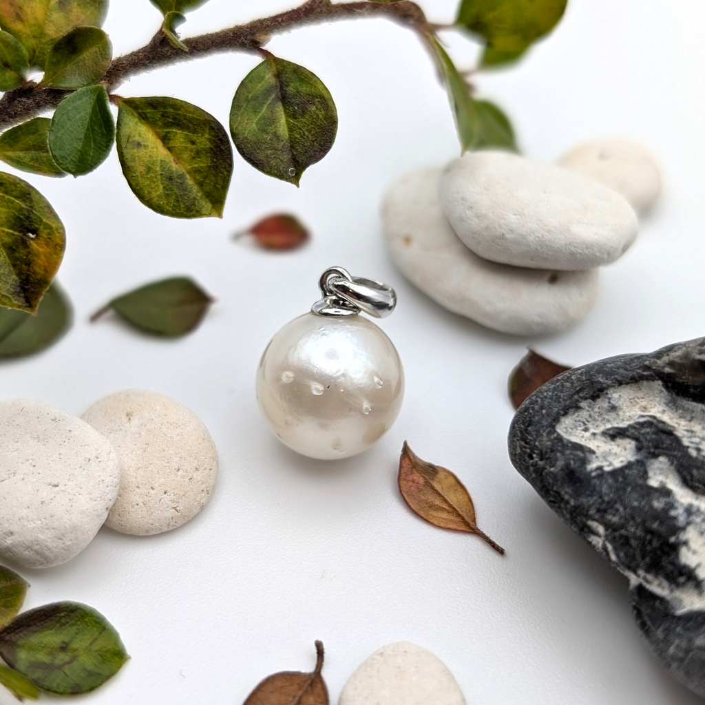 large spotted white south sea pearl pendant on white background